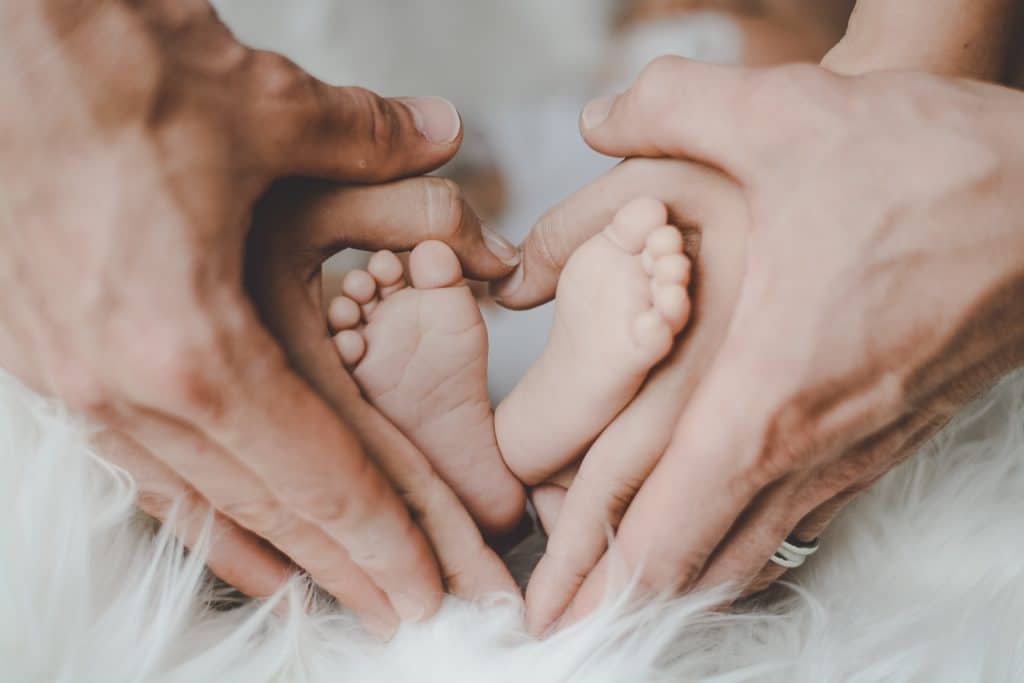 Parents massaging baby's feet