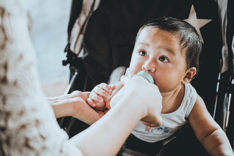 Baby using bottle